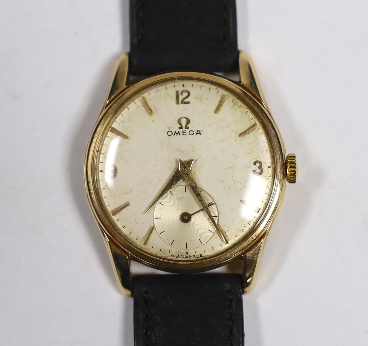 A gentleman's 9ct gold Omega manual wind wrist watch, with case back inscription, on associated leather strap, case diameter 34mm.